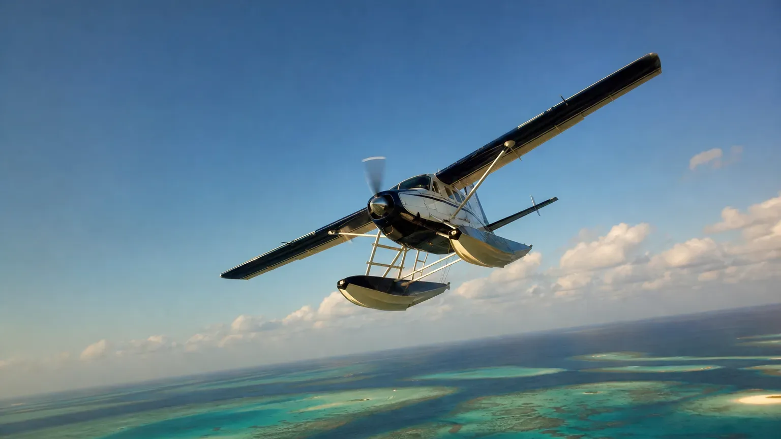 A seaplane with floats banks steeply over turquoise reef-scattered shallows beneath a wide blue sky with scattered clouds